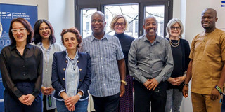 Eight smiling people at the UA Ruhr's College of Social Sciences and Humanities