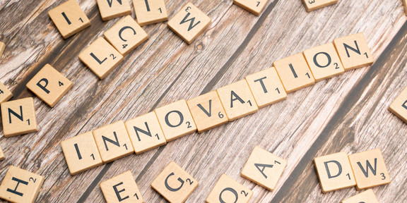 The word Innovation made out of Scrabble tiles